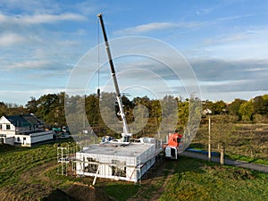 Aerial view of a family home being built with a crane