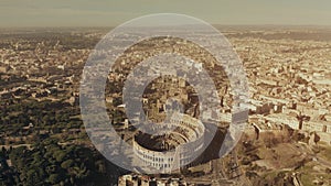 Aerial view of famous Colosseum or Coliseum amphitheatre within cityscape of Rome, Italy