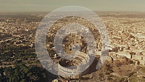 Aerial view of famous Colosseum or Coliseum amphitheatre within cityscape of Rome, Italy