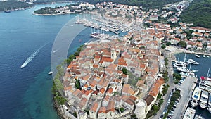 Aerial view of famous Croatian island Korcula, with mediterranean architecture, marina and luxury yachts and sailboats embarked.