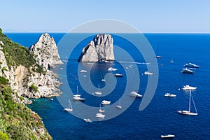 Aerial view of famous Faraglioni cliffs and Tyrrhenian sea on a beautiful summer day on Capri island in Italy