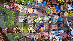 Aerial view famous floating market in Thailand, Damnoen Saduak floating market, Farmer go to sell organic products, fruits,