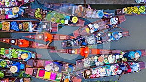 Aerial view famous floating market in Thailand, Damnoen Saduak floating market, Farmer go to sell organic products, fruits,