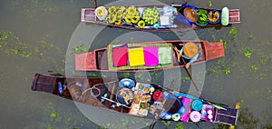 Aerial view famous floating market in Thailand, Damnoen Saduak floating market, Farmer go to sell organic products, fruits,