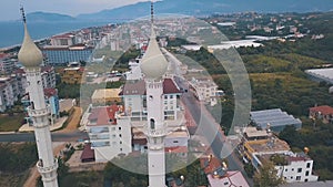 Aerial view of the famous mosque and the minaret on the castle hill against blue sky in Alanya,Turkey. Clip. Historical