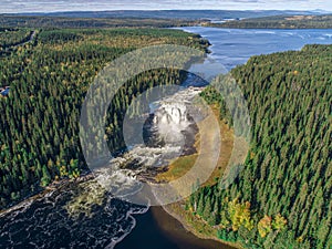 Aerial view famous waterfall Tannforsen northern Sweden, with a rainbow in the mist and rapid flowing cascades of water