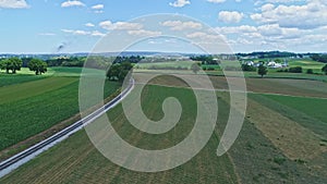 Aerial View of the Farm Countryside With Planted Fields and a Single Rail Road Track on a Curve