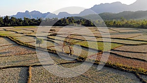 Aerial view of farm fields and rock formations in Vang Vieng, Laos. Vang Vieng is a popular destination for adventure
