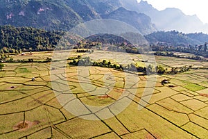 Aerial view of farm fields and rock formations in Vang Vieng, Laos. Vang Vieng is a popular destination for adventure tourism in