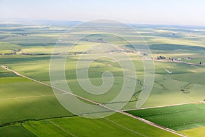 An aerial view of farm Land with green crops.