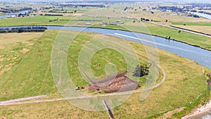 Aerial view of the farm surrounded by a beautiful river and lush green grass near Newcastle