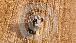 Aerial view of farmer using combine to harvest crops