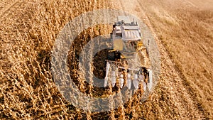 Aerial view of farmer using tractor, harvesting combine and tools to harvest