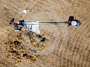 Aerial view of farmers harvesting wheat
