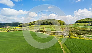 Aerial View of farming land with crop field, pasture and orchard