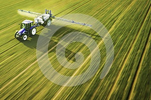 Aerial view of farming tractor  spraying on field