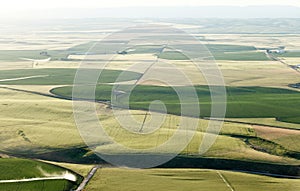 An aerial view of farmland irrigated with center pivot sprinkler systems.