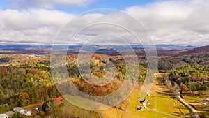 Aerial view of Farmland in the mountains during fall during partly cloudy weather photo