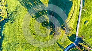 Aerial view on a farmland with roads and livestock paddock on a hills near New Plymouth. Taranaki region, New Zealand