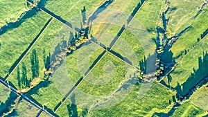 Aerial view on a farmland with roads and livestock paddock on a hills near New Plymouth. Taranaki region, New Zealand