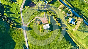 Aerial view on a farmland with roads and small houses. Taranaki region, New Zealand