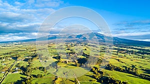 Aerial view on a farmland with stock paddocks at the foot of Mount Taranaki. Taranaki region, New Zealand