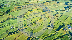 Aerial view on a farmland with stock paddocks at the foot of Mount Taranaki. Taranaki region, New Zealand