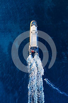 Aerial view on fast boat on blue Mediterranean sea at sunny day. Fast ship on the sea surface. Seascape from the drone. Seascape f