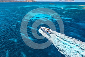 Aerial view of fast floating yacht on blue sea at sunny day