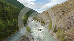 Aerial view fast movement wild water flow mount river with stones narrow gorge autumn scenery