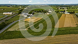 Aerial View Featuring Roads Intersecting Near Construction Site Amidst Farmland With Fields