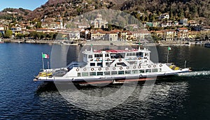 Aerial view of ferry boat that leaves from the port of Laveno Mombello. Passenger transport with vehicles, navigation on Lake Magg