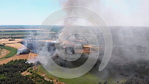 Aerial View of Fire in Wheat Field. Flying over Smoke above Agricultural Fields