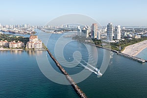 Aerial view Fisher Island, Miami Beach, Port Miami and Miami skyline at sunrise.