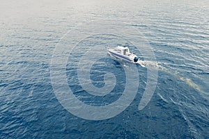 Aerial view fisherman on boat at the ocean. Top view beautiful seascape with the fishing boat. Aerial view fishing motor boat with