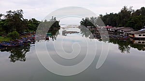 Aerial view of fisherman village near the coast. calm water reflection. rural scene.