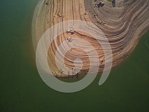 Aerial view of fishermen in the swamp of ValdecaÃ±as, with green water by algae and natural lines of the descent of water. Natural