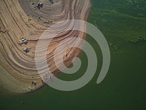 Aerial view of fishermen in the swamp of ValdecaÃ±as, with green water by algae and natural lines of the descent of water. Natural