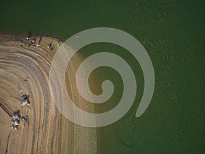 Aerial view of fishermen in the swamp of ValdecaÃ±as, with green water by algae and natural lines of the descent of water. Natural