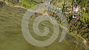 Aerial view of fishing boat near shore. Small boat floating on the lake near the pier. Relax concept for design