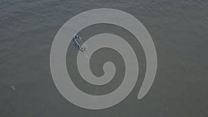 Aerial view fishing boat sails in the sea. White boat floats on the open sea on a sunny day