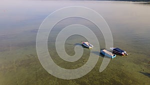 Aerial view of fishing boats near shore. Small boats floating on the lake near the pier. Relax concept for design