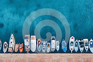 Aerial view of the fishing boats and yachts on tropical sea coast