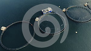 Aerial view of fishing farm enclosures on blue watersurface