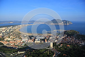 Aerial view of a fishing village on a bright day under blue sky.