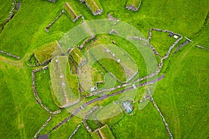 Aerial view of fishing village in Koltur island. Faroe Islands. Green roof houses. Photo made by drone from above. Nordic natural