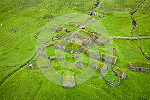 Aerial view of fishing village in Koltur island. Faroe Islands. Green roof houses. Photo made by drone from above. Nordic natural