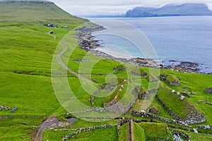 Aerial view of fishing village in Koltur island. Faroe Islands. Green roof houses. Photo made by drone from above. Nordic natural