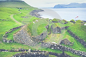 Aerial view of fishing village in Koltur island. Faroe Islands. Green roof houses. Photo made by drone from above. Nordic natural photo