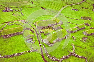 Aerial view of fishing village in Koltur island. Faroe Islands. Green roof houses. Photo made by drone from above. Nordic natural